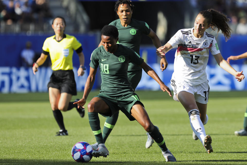 Nigeria's Halimatu Ayinde, left, vies for the ball with Germany's Sara Daebritz during the Women's World Cup round of 16 soccer match between Germany and Nigeria at Stade del Alpes in Grenoble, France, Saturday, June 22, 2019. Daebritz scored once in Germany's 3-0 victory. (AP Photo/Laurent Cipriani)