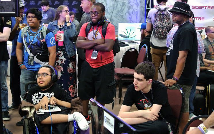 Tim Jones (far right) watches his son Dayton 'Wheels' Jones play in Killer Instinct pools at Combo Breaker