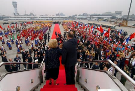 FILE PHOTO: File photo of French President Jacques Chirac and his wife Bernadette waving as they leave Chengdu