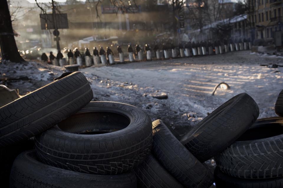 Riot police officers cordon off the area near a barricade heading to Kiev's Independence Square, the epicenter of the country's current unrest, Ukraine, Monday, Feb. 3, 2014. Ukraine's president will return Monday from a short sick leave that had sparked a guessing game he was taking himself out of action in preparation to step down or for a crackdown on widespread anti-government protests. (AP Photo/Emilio Morenatti)