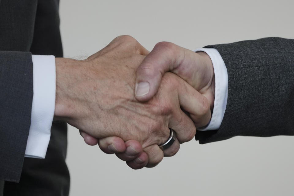 German Chancellor Olaf Scholz, right, and Intel CEO Pat Gelsinger, left, shake hands after the signing ceremoy of an agreement between the German government and the company at the Chancellery in Berlin, Germany, Monday, June 19, 2023. (AP Photo/Markus Schreiber)