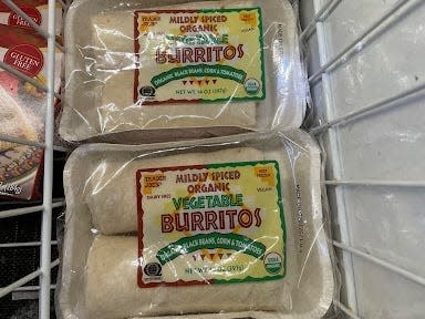 packages of trader joe's vegetable burritos in the frozen aisle