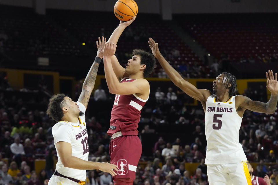 Stanford Cardinal forward Brandon Angel (23) shoots over Arizona State guards Jose Perez (12) and Jamiya Neal (5) during the first half of an NCAA college basketball game Thursday, Feb. 1, 2024, in Tempe, Ariz. (AP Photo/Ross D. Franklin)