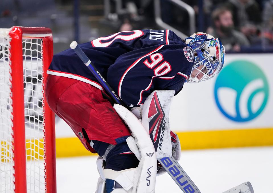 Columbus Blue Jackets goaltender Elvis Merzlikins (90) reacts to giving up a goal to Calgary Flames left wing Andrew Mangiapane during the second period of the NHL hockey game at Nationwide Arena in Columbus on Wednesday, Jan. 26, 2022. 