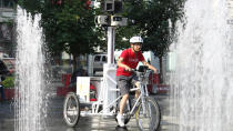 Jonathan Chang, 27, rides the Google Street View trike around Yonge-Dundas Square in Toronto. 