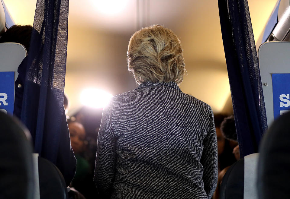 Democratic presidential nominee Hillary Clinton speaks to reporters aboard her campaign plane at Chicago Midway Airport on Sept. 29, 2016.
