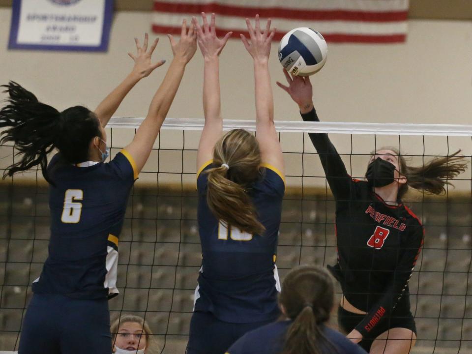 Penfield's Eleanor Dorritie (8), right, spikes the ball past the defense of Victor's Helen Qian (6), left, and Kaitlin Murphy (10) during their Section V Class AA championship finals match up Saturday, Nov. 6, 2021 at Gates Chili High School.  