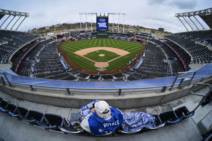 One Kansas City Royals fan arrived early with plenty of cold-weather gear for the home opener against the Cleveland Guardians before the start of a baseball game, Thursday, April 7, 2022 in Kansas City, Mo. (AP Photo/Reed Hoffmann)