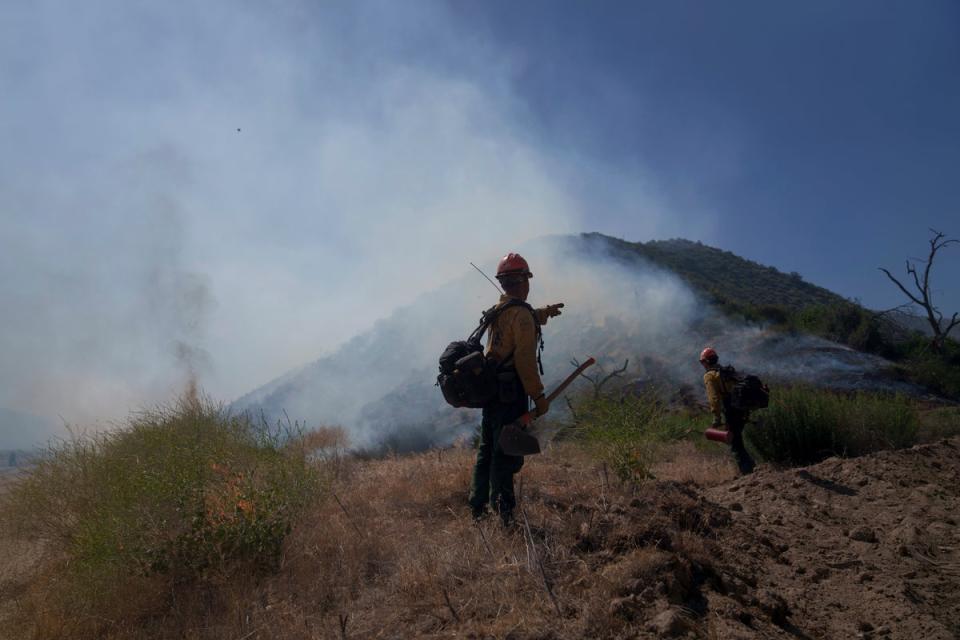 Firefighters work against the advancing Post Fire on Sunday, June 16, 2024, in Lebec, California (AP)