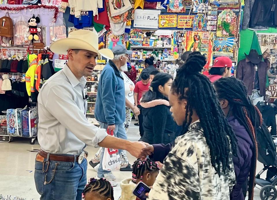 Eddie Garcia talks with a family as they wait in line to visit Santa Claus at the Jefferson Davis Flea Market in North Chesterfield in December.