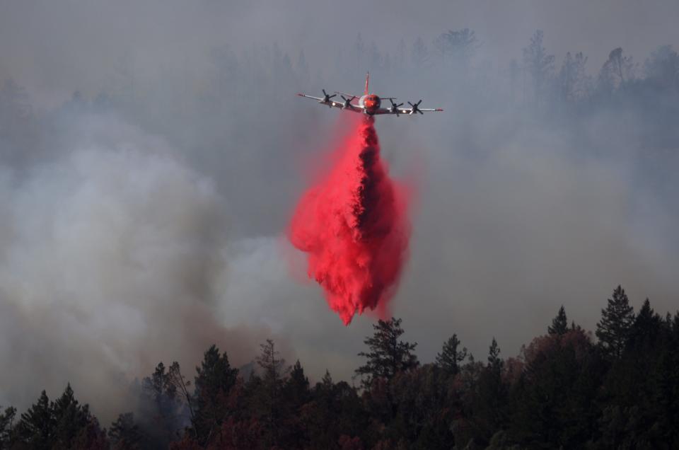 A plane drops retardant on the Glass Fire last September (Getty)