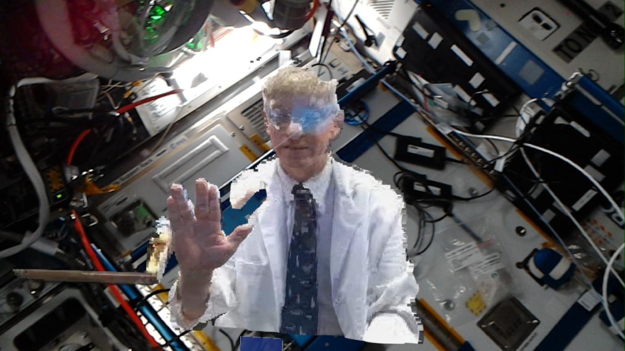 NASA flight surgeon, Dr. Josef Schmid gives a space greeting (NASA) 