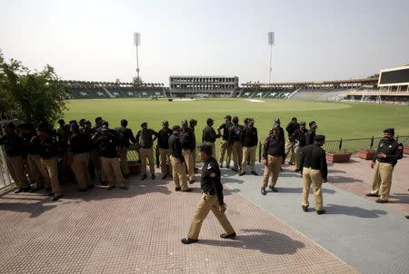 Policemen stand inside the Gaddafi Stadium during preparation ahead of cricket series between Pakistan and Zimbabwe in Lahore, Pakistan, May 16, 2015. REUTERS/Mohsin Raza