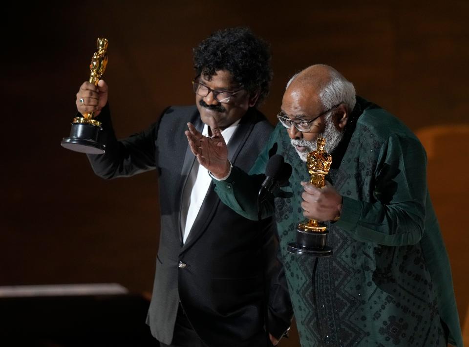 M.M. Keeravaani, right, and Chandrabose accept the award for best original song for "Naatu Naatu" from "RRR" during the 95th Academy Awards.