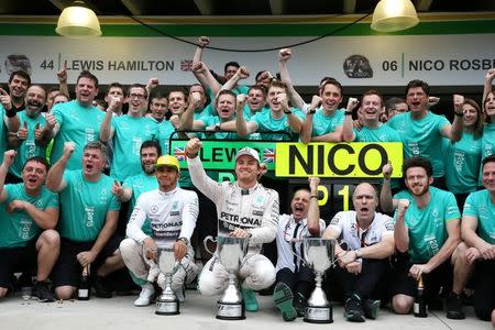 Formula One - F1 - Brazilian Grand Prix 2015 - Autodromo Jose Carlos Pace, Sao Paulo, Brazil - 15/11/15 Mercedes' Nico Rosberg and Lewis Hamilton celebrate after finishing first and second respectively Mandatory Credit: Action Images / Hoch Zwei Livepic