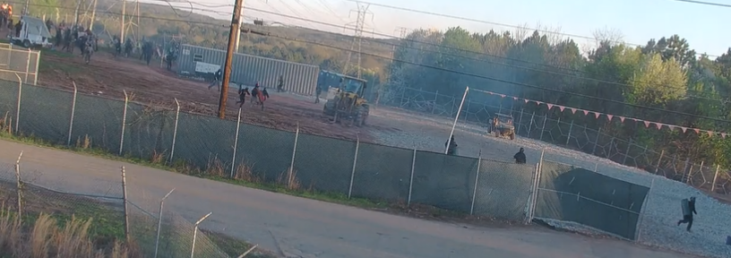 Hundreds of activists dressed in black breached a proposed police and fire training center site in Atlanta on Sunday, burning police and construction vehicles, and setting off fireworks toward officers stationed nearby.