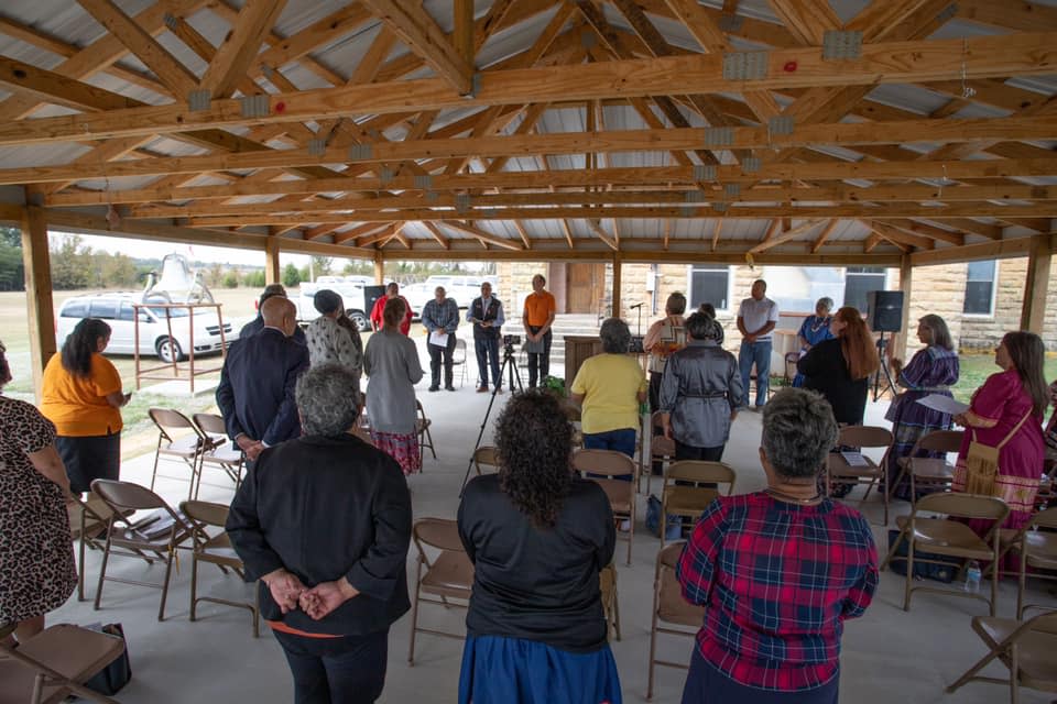 People participate in the Oklahoma Indian Missionary Conference of the United Methodist Church's remembrance service for children who experienced the Native American boarding school era. The event was held in the open-air tabernacle at Thlopthlocco United Methodist Church near Okemah.