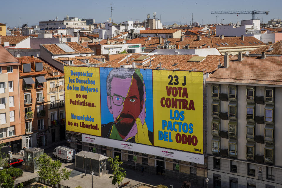 A huge banner is displayed Pedro Zerolo Square, urging people to vote against the possible allegiance between center-right wing Popular Party and Vox, the extreme right party, in Madrid, Spain, Saturday, July 15, 2023. The banner reads in Spanish: "Disregarding women's rights is not patriotism. Homophobia is not freedom. Vote against hate deals". (AP Photo/Bernat Armangue)