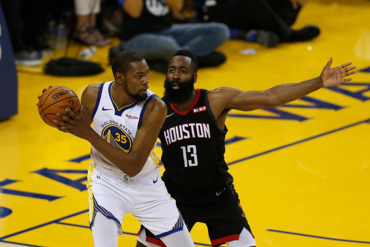 OAKLAND, CALIFORNIA - MAY 08: Kevin Durant #35 of the Golden State Warriors is guarded by James Harden #13 of the Houston Rockets during Game Five of the Western Conference Semifinals of the 2019 NBA Playoffs at ORACLE Arena on May 08, 2019 in Oakland, California. NOTE TO USER: User expressly acknowledges and agrees that, by downloading and or using this photograph, User is consenting to the terms and conditions of the Getty Images License Agreement. (Photo by Lachlan Cunningham/Getty Images)