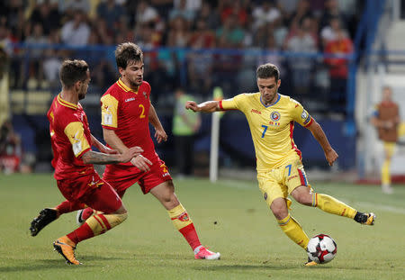 Soccer Football - 2018 World Cup Qualifications - Europe - Montenegro vs Romania - Podgorica, Montenegro - September 4, 2017 - Romania's Alexandru Chipciu in action with Montenegro's Filip Stojkovic and Marko Vesovic. REUTERS/Stevo Vasiljevic