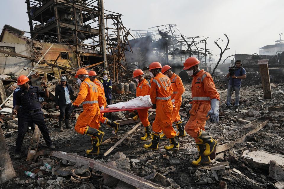 National Disaster Response Force rescuers carry the dead body of a person after an explosion and fire at a chemical factory in Dombivali near Mumbai, India, Friday, May 24, 2024. Multiple people were killed and dozens were injured in the incident that happened Thursday. (AP Photo/Rajanish Kakade)