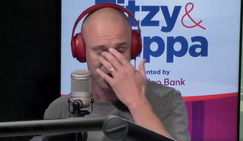 Fitzy holding his hand up to his face crying on the Fitzy & Wippa Show