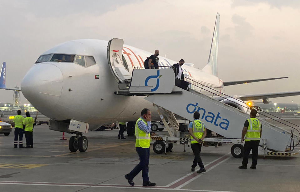 FILE - Tourists leave a flydubai plane which departed from Ben-Gurion International Airport in Tel Aviv and landed in Dubai, United Arab Emirates, Nov. 8, 2020. Dubai-based budget carrier FlyDubai saw record profits of $572 million in 2023, boosted by carrying the most passengers ever across its network, the company announced Thursday, Feb. 22, 2024. (AP Photo/Malak Harb, File)