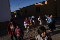 Children leave at the end of the school day in Huancar, Jujuy Province, Argentina, Tuesday, April 25, 2023. The Andean town is prospering because of the work available in nearby lithium mines. (AP Photo/Rodrigo Abd)