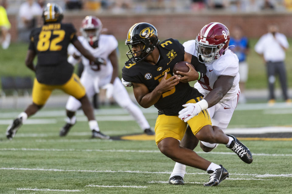 Missouri starting quarterback Shawn Robinson, left, is sacked by Alabama's Christian Harris, right, during the first quarter of an NCAA college football game Saturday, Sept. 26, 2020, in Columbia, Mo. (AP Photo/L.G. Patterson)