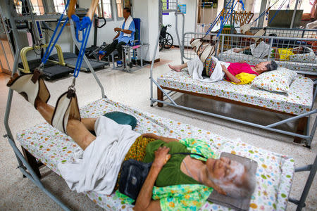 Elderly people lie in beds during a physical therapy session at Bangkhae Home Foundation in Bangkok, Thailand, April 27, 2016. REUTERS/Athit Perawongmetha