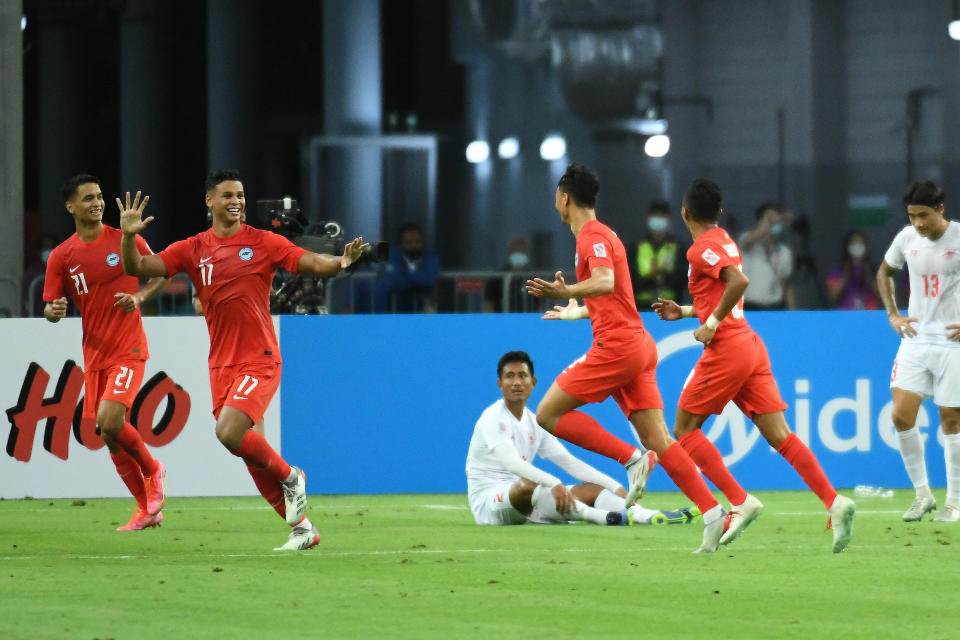 Singapore players celebrate scoring against Myanmar in their AFF Suzuki Cup Group A match at National Stadium.