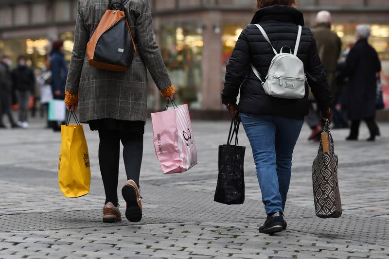 Women with shopping bags walk through the city center in Nuremberg