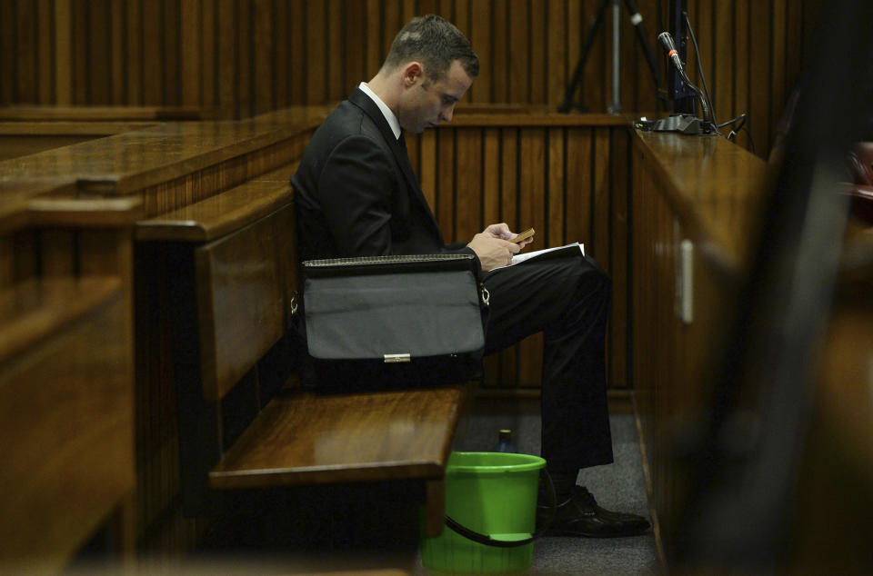 Oscar Pistorius sits in the dock during his murder trial at a court in Pretoria, South Africa, Friday, March 14, 2014. Pistorius is charged with the shooting death of his girlfriend Reeva Steenkamp, on Valentines Day in 2013. (AP Photo/Phill Magakoe, Pool)