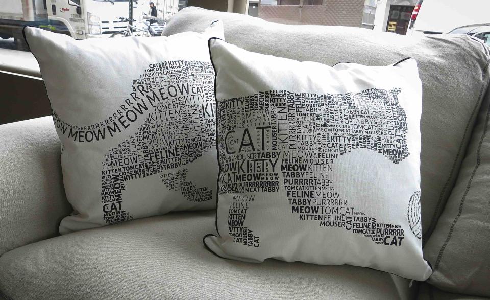 Two sofa cushions that go together to make an image of a cat is pictured at the cat cafe in New York April 23, 2014. The cat cafe is a pop-up promotional cafe that features cats and beverages in the Bowery section of Manhattan.