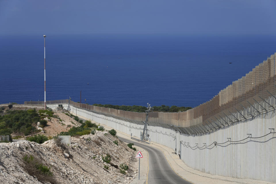 FILE - The border wall runs between Israel and Lebanon with the Mediterranean Sea in the distance, in Rosh Hanikra, Israel, on Oct. 14, 2022. (AP Photo/Tsafrir Abayov, File)