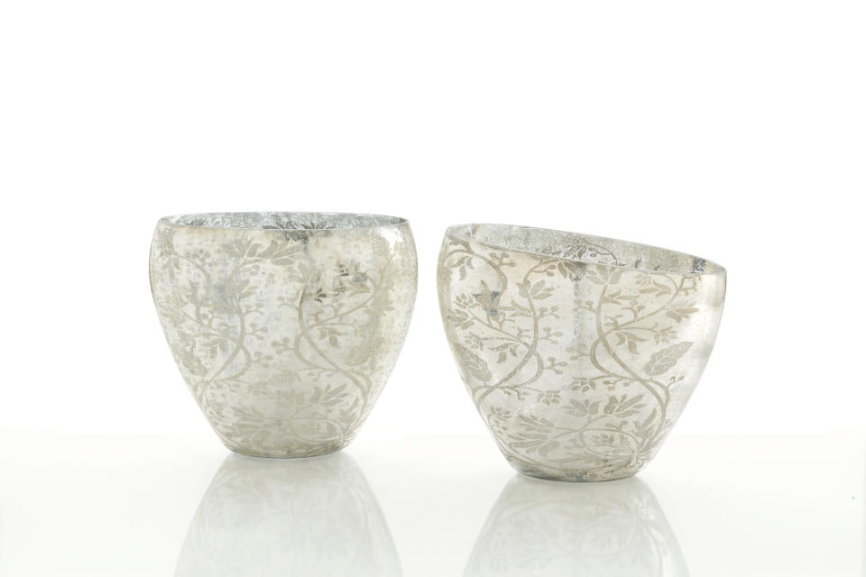 This publicity product photo provided by Laylagrayce.com shows two Naples vases from Arteriors. The vase has a soft floral and vine design on mercury glass that gives it a light, garden-inspired look. (AP Photo/Laylagrayce.com)