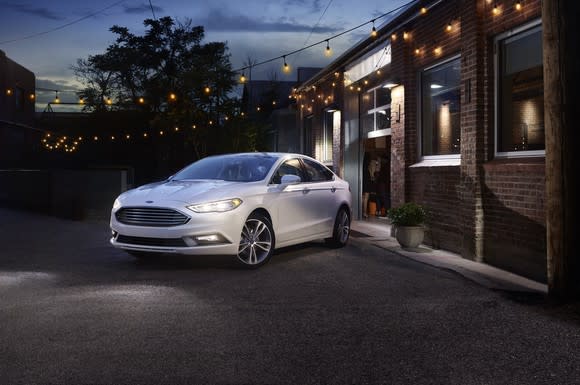 Ford's Fusion parked in a driveway at night
