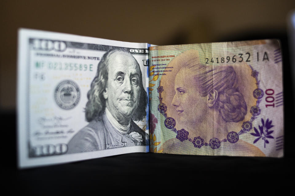 United States one hundred dollar bill and Argentine one hundred pesos bill are seen in this picture illustration taken in Buenos Aires, Argentina November 9, 2021. (Photo by Mat&#xed;as Baglietto/NurPhoto via Getty Images)