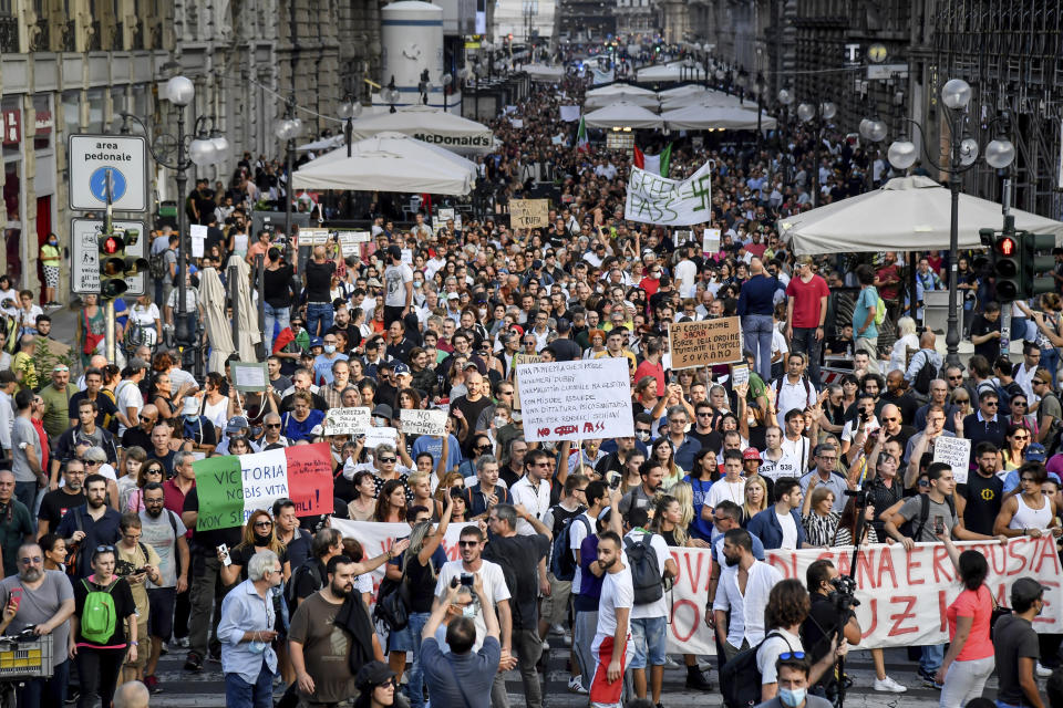 People march during a protest against the COVID-19 health pass, in Milan, Italy, Saturday, Sept. 18, 2021. Italian workers in both the public and private sectors must display a health pass to access their workplaces from Oct. 15 under a decree adopted by Premier Mario Draghi’s broad-based coalition government. (Claudio Furlan/LaPresse via AP)