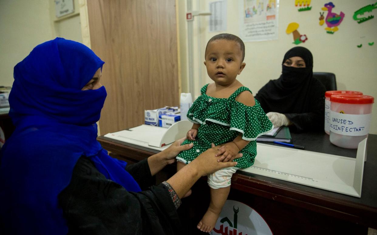 A 10-month-old girl is checked at a stunting clinic in Pakistan - Saiyna Bashir