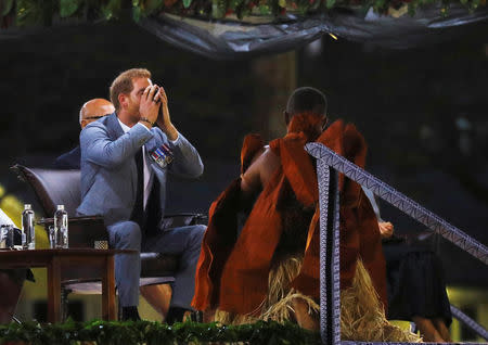 Britain’s Prince Harry drinks kava during a ceremony as he and Meghan, the Duchess of Sussex attend an official welcome at Albert Park in Suva, Fiji October 23, 2018. REUTERS/Phil Noble