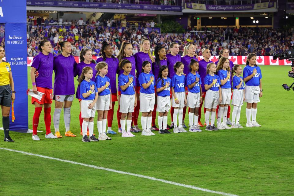 Canada stands for the national anthem before Thursday night's SheBelieves Cup game against the USA at Exploria Stadium.