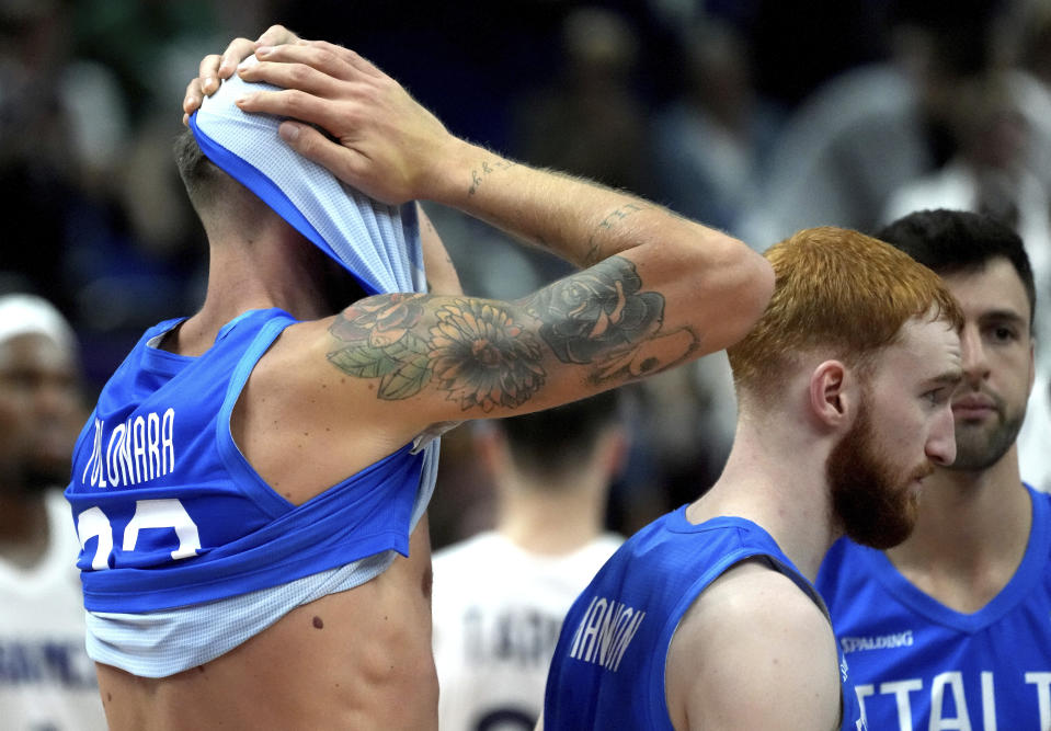 Italy's Achille Polonara, left, reacts after the Eurobasket quarter final basketball match between France and Italy in Berlin, Germany, Wednesday, Sept. 14, 2022. France defeated Italy by 93-85. (AP Photo/Michael Sohn)