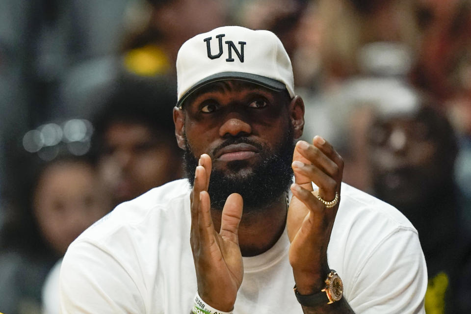 Los Angeles Lakers forward LeBron James reacts during the first half of a preseason NBA basketball game against the Sacramento Kings Wednesday, Oct. 11, 2023, in Anaheim, Calif. (AP Photo/Ryan Sun)