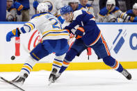 New York Islanders defenseman Noah Dobson (8) moves the puck around Buffalo Sabres left wing Zemgus Girgensons (28) during the second period of an NHL hockey game, Saturday, March 25, 2023, in Elmont, N.Y. (AP Photo/Mary Altaffer)