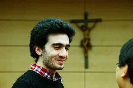 Syrian refugee Anas Modamani accompanied by his lawyer Chan-Jo Jun attends a court session against Facebook over a selfie with Merkel at the district court in Wuerzburg, Germany February 6, 2017. REUTERS/Ralph Orlowski