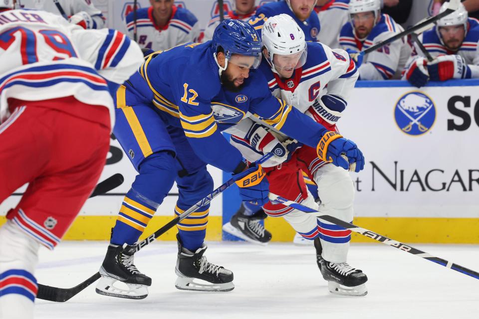 Buffalo Sabres left wing Jordan Greenway (12) and New York Rangers defenseman Jacob Trouba (8) collide during the first period of an NHL hockey game Thursday, Oct. 12, 2023, in Buffalo, N.Y.