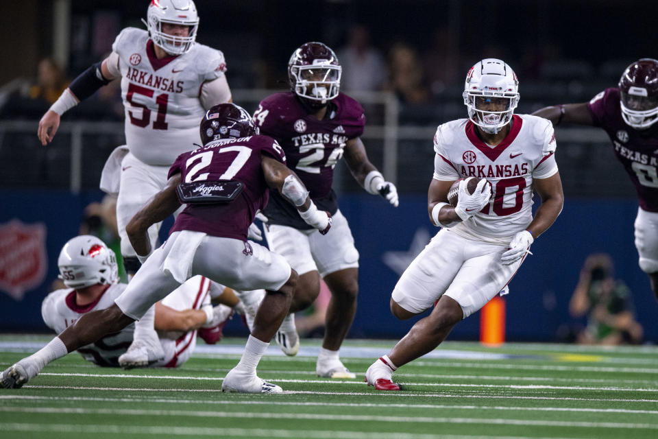 Sep 24, 2022; Arlington, Texas, USA; Arkansas Razorbacks running back Dominique Johnson (20) attempts to elude Texas A&M Aggies defensive back Antonio Johnson (27) during the second quarter at AT&T Stadium. Mandatory Credit: Jerome Miron-USA TODAY Sports