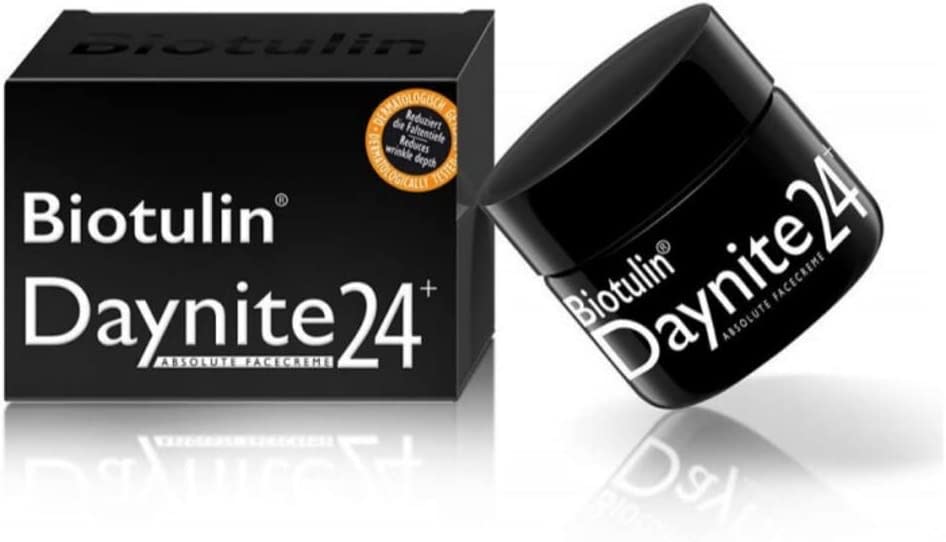 A black tub of Biotulin Daynite24 cream, with white lettering, sits next to its black packaging on a plain background.