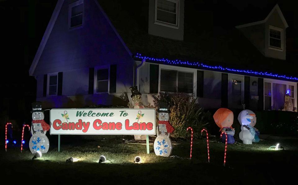 A Candy Cane Lane sign welcomes people to Candy Cane Lane in West Allis Sunday, Nov. 29, 2020.  This is the 35th year for the event, which is held Nov. 27-Dec. 27. 